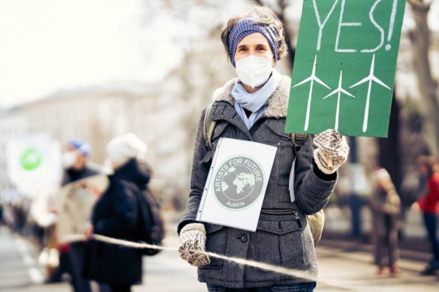 Menschen mit Plakaten bei Klimastreik artist for future